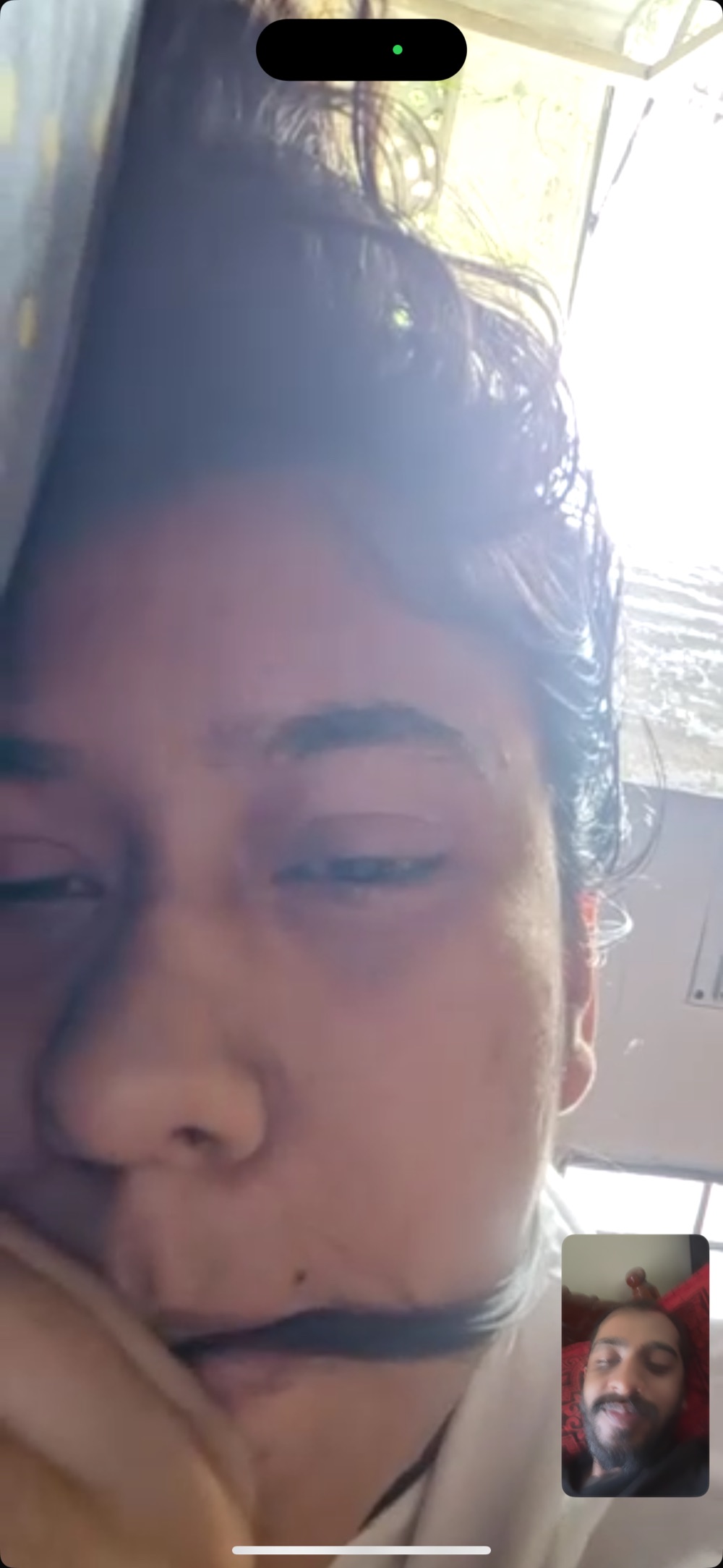flat on the bed, chewing her hair